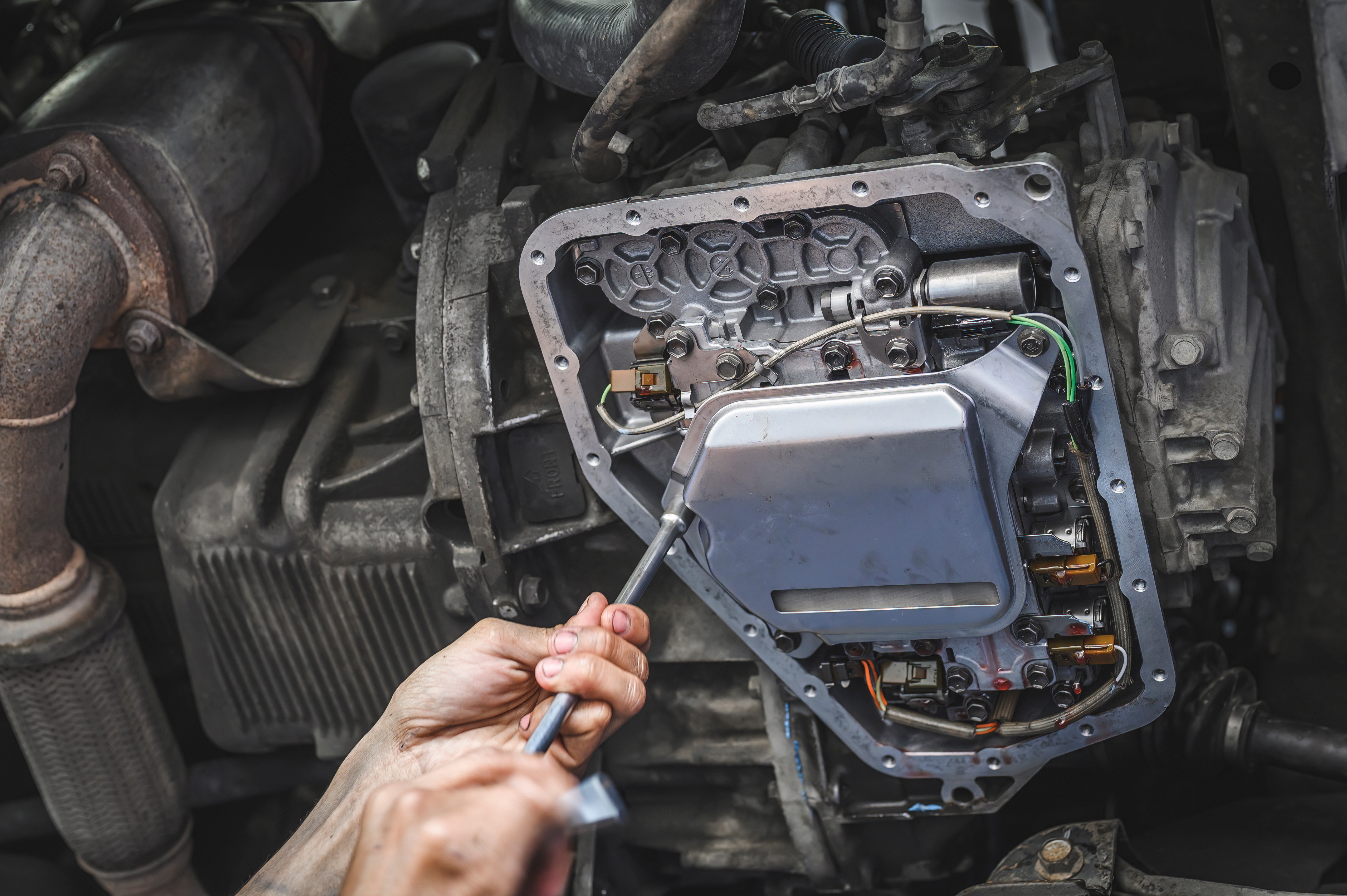 Technician working on transmission valve body